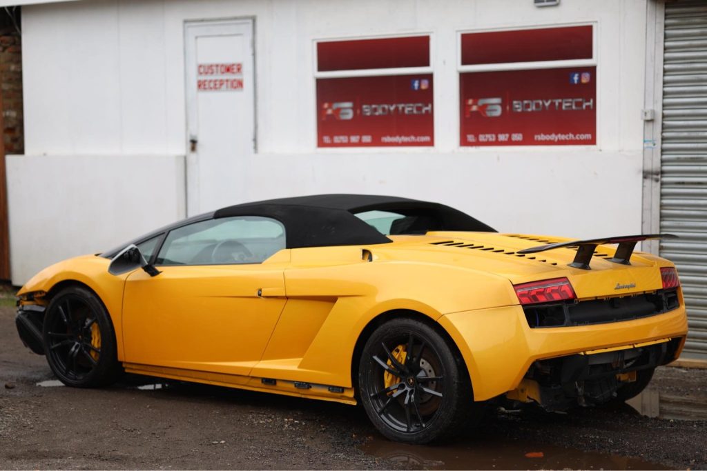 Yellow sports car in front of garage