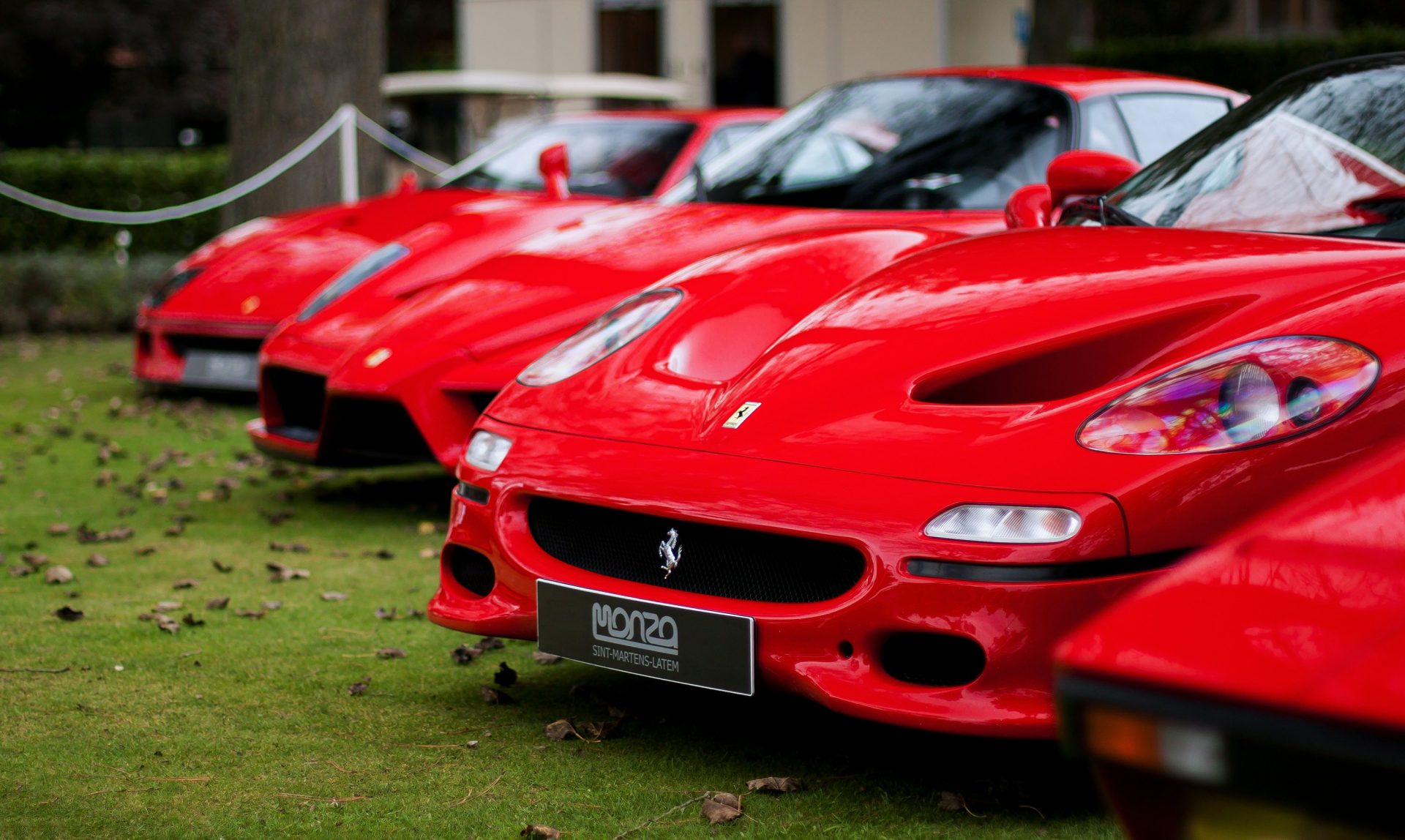 Row of red sports cars on display